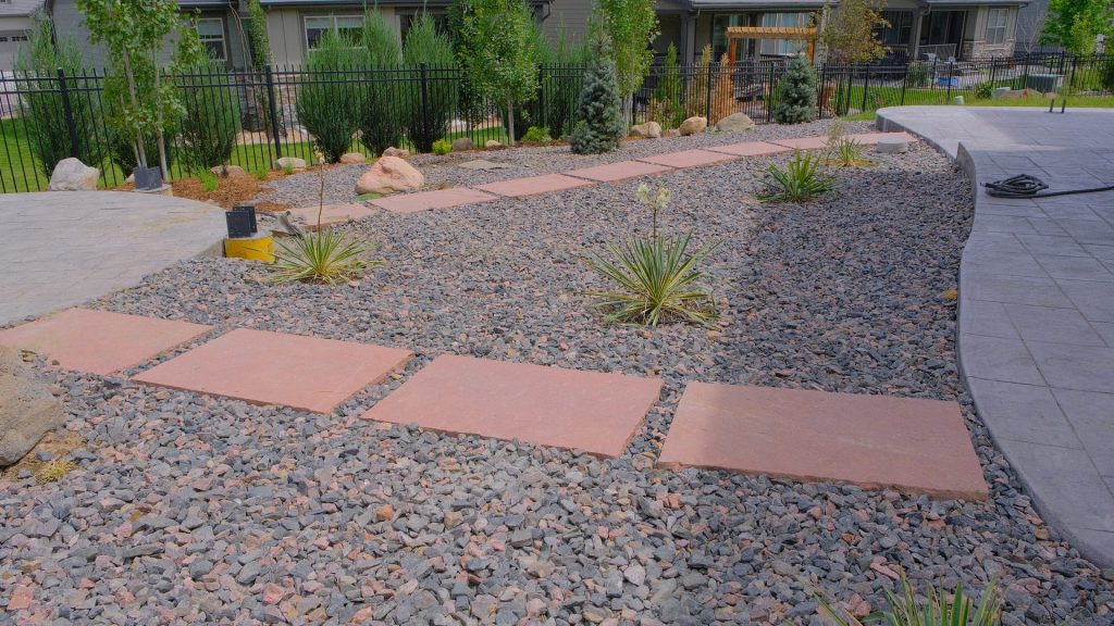 Xeriscaping 10 morrison-co-hardscaping-landscaping-xeriscape-sandstone-stepping-path-dark-gravel-yucca-blue-spruce