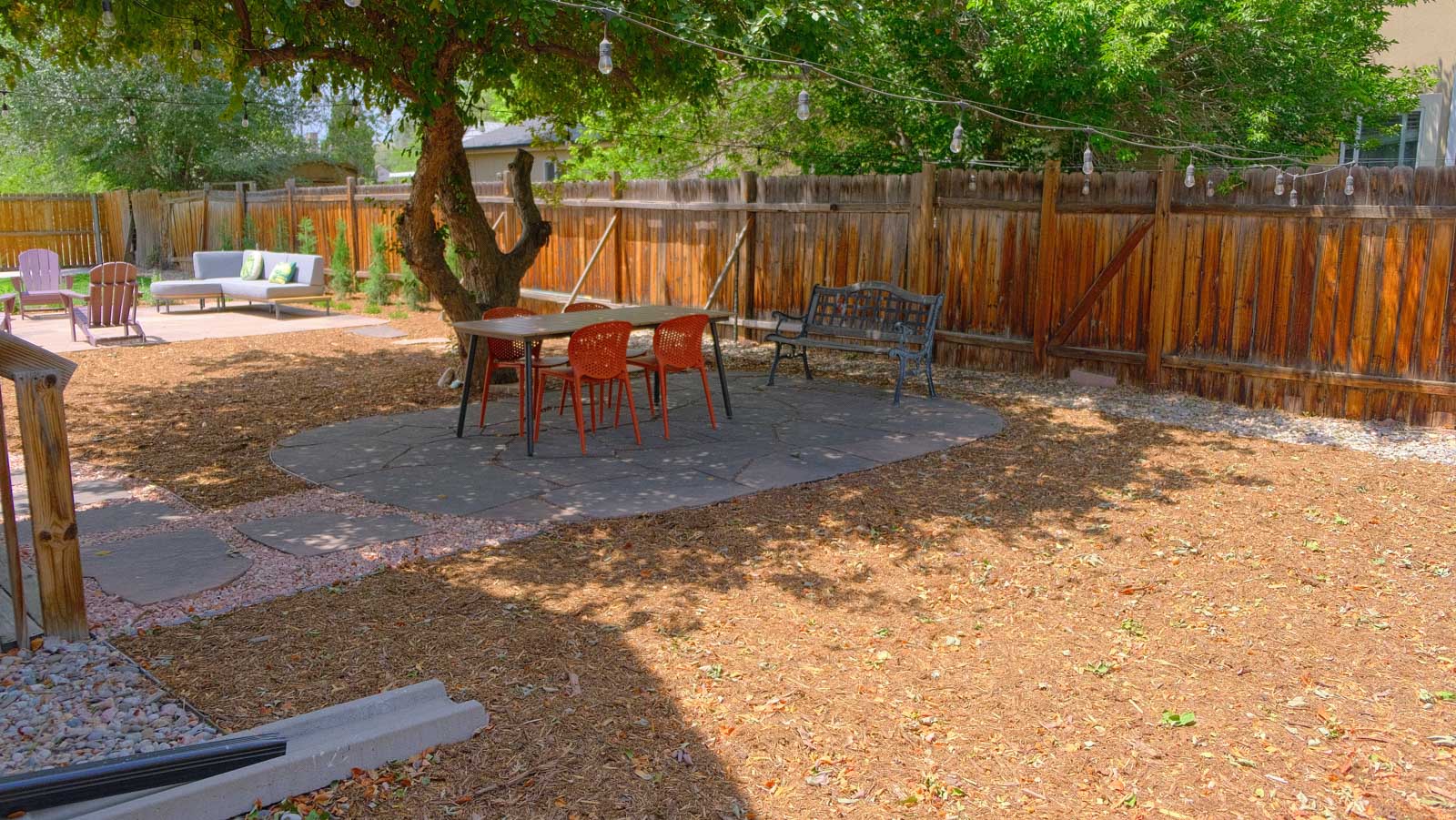 west-denver-landscaping-shade-tree-dining-area-flagstone-patio-string-lights-after